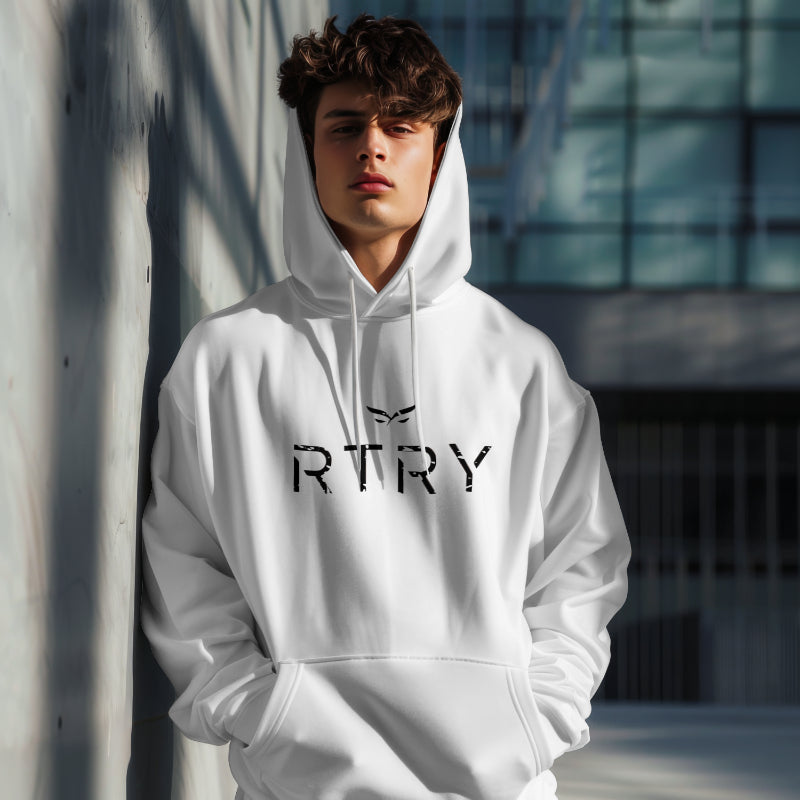 Person wearing a white hoodie with 'RTRY' text against a modern building background